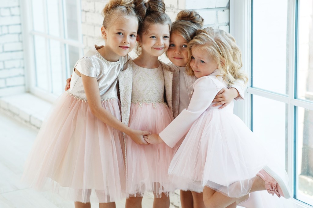 Claudia Schmidt posing with little girls with beautiful dresses