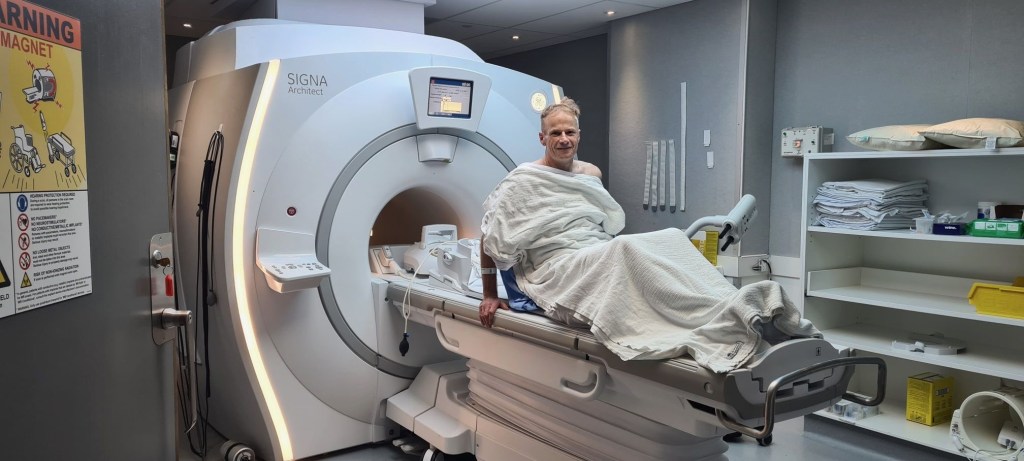 SCOLYER poses in and Mri Machine