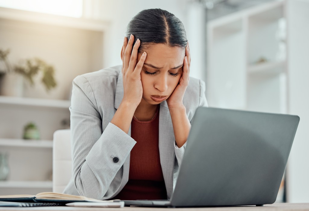 New Stressed Businessman experiencing headaches while working for financial problems in an initial office