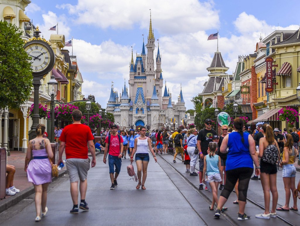 People walking through Main Street, USA towards the Cinderella Fortress at Disney World.