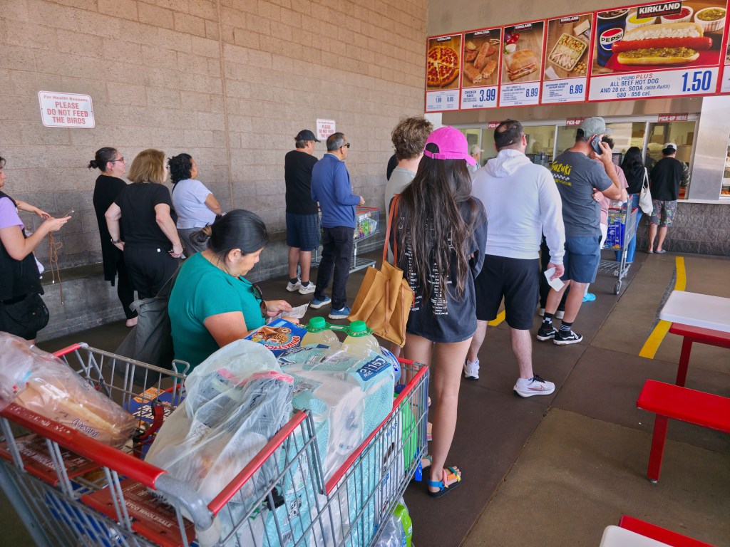 Customers waiting in line in a Costco Food Court.